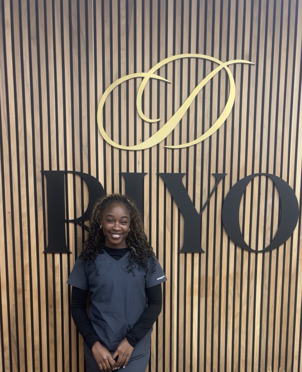 Elizabeth Sungu, Dental Nurse at Riyo Dental, in staff portrait.