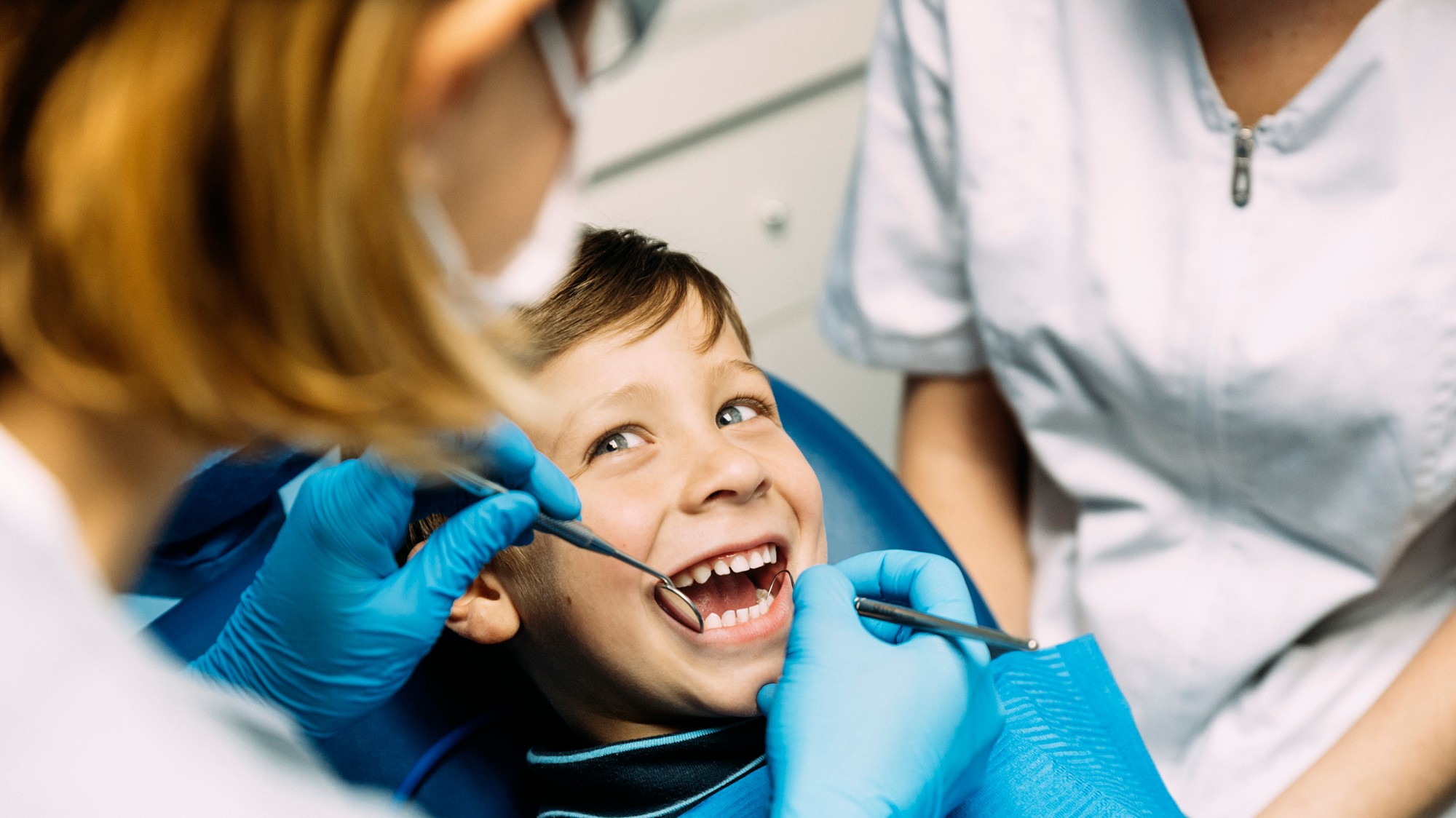 Dentist performing a dental check-up on a child to assess oral health