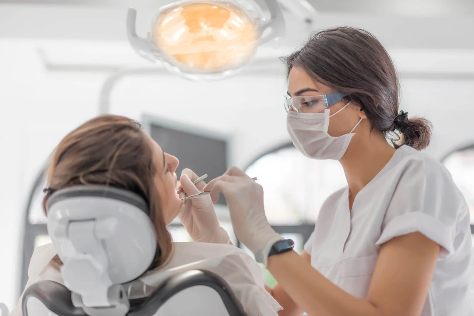 Dentist conducting a dental examination on a new patient during their first visit
