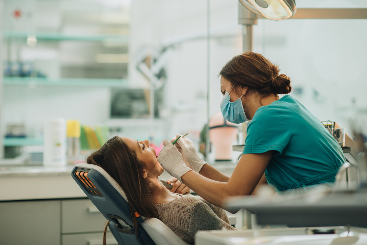 Woman receiving a dental procedure from a dentist