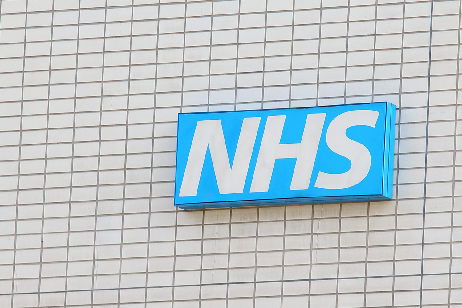 NHS logo displayed on the side of a building