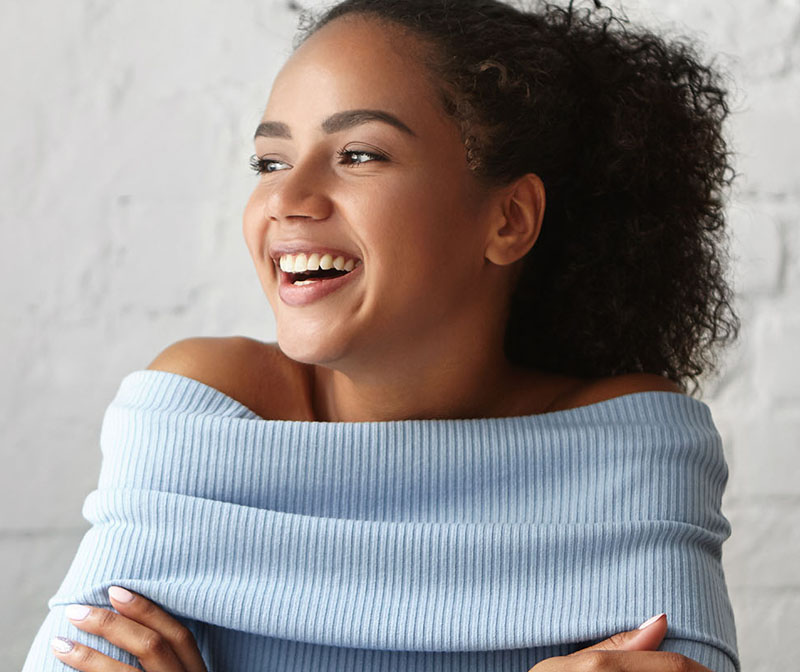 Close-up of a woman with white, straight teeth smiling