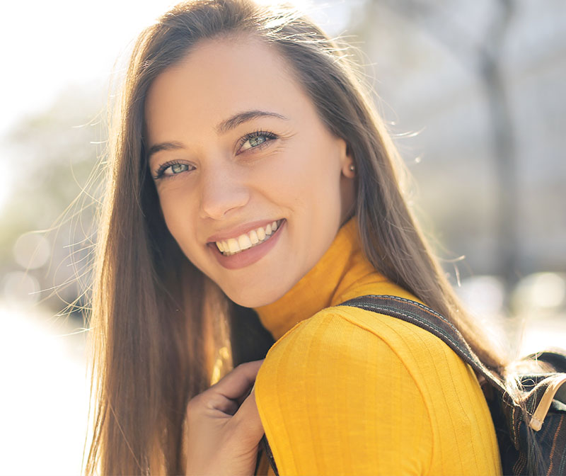 Brunette Woman Smiling In Yellow Top